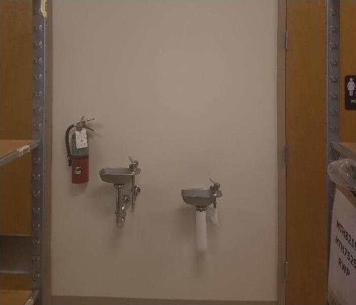 wall with two water fountains and fire extinguisher in Memphis, TN
