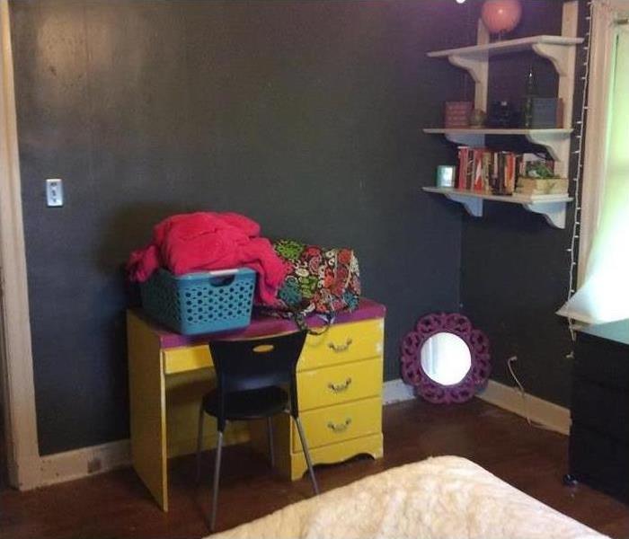 clean bedroom in Memphis, TN with yellow desk and shelves