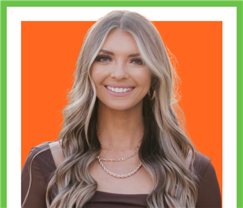 Female profile photo, against orange background