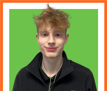 SERVPRO employee in front of green background