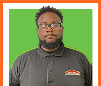 Justin, SERVPRO employee, cut out and set against a green backdrop
