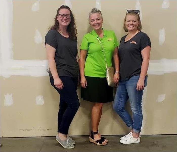 three SERVPRO of Southeast Memphis employees pictured in front of a blank wall